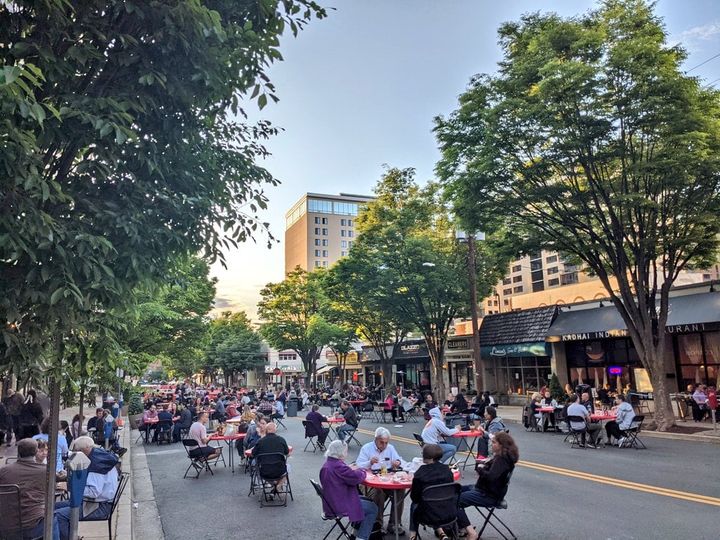 Photo of people enjoying the Bethesda Streetery by dining in the driving lanes